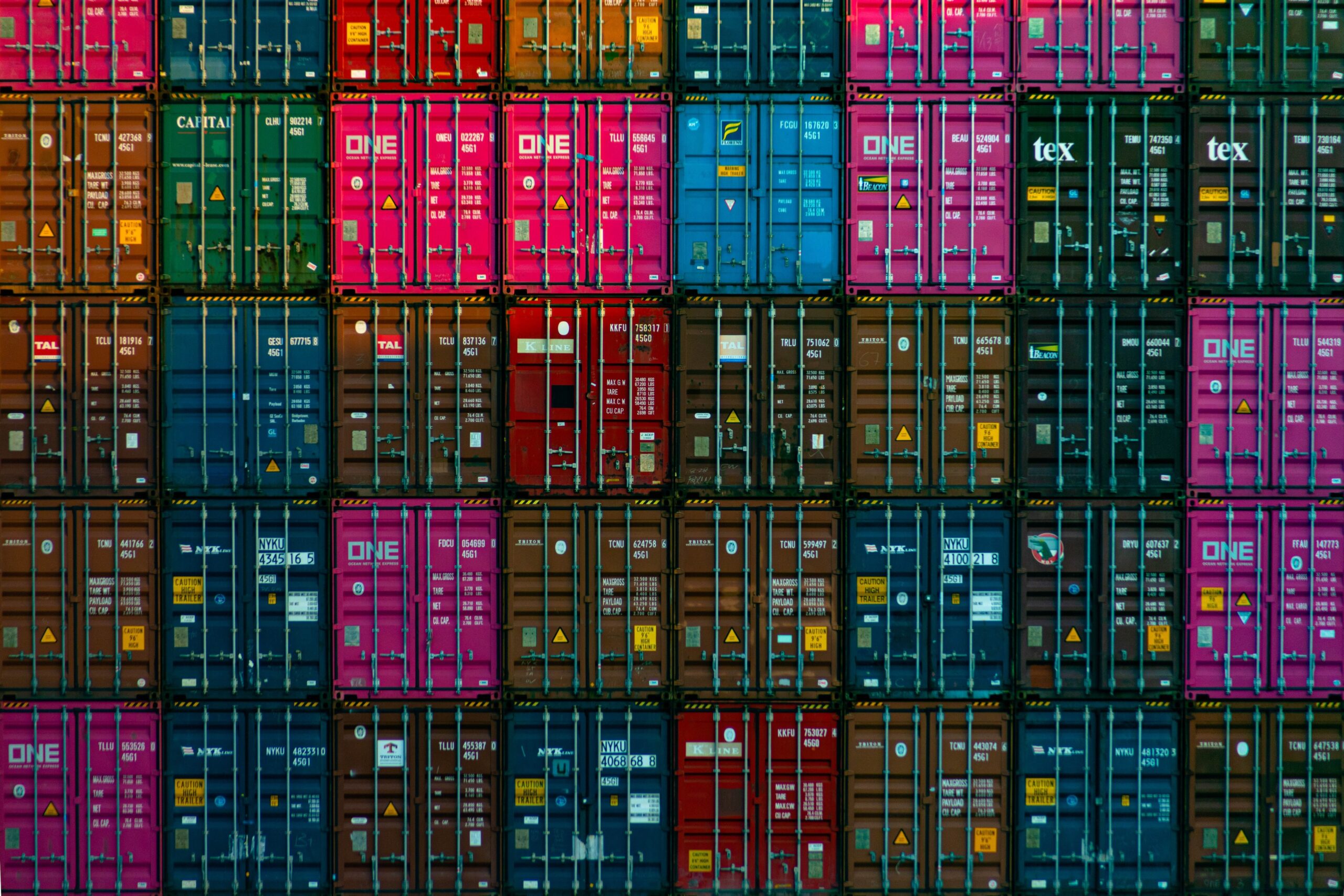 Wall of colorful stacked cargo containers.